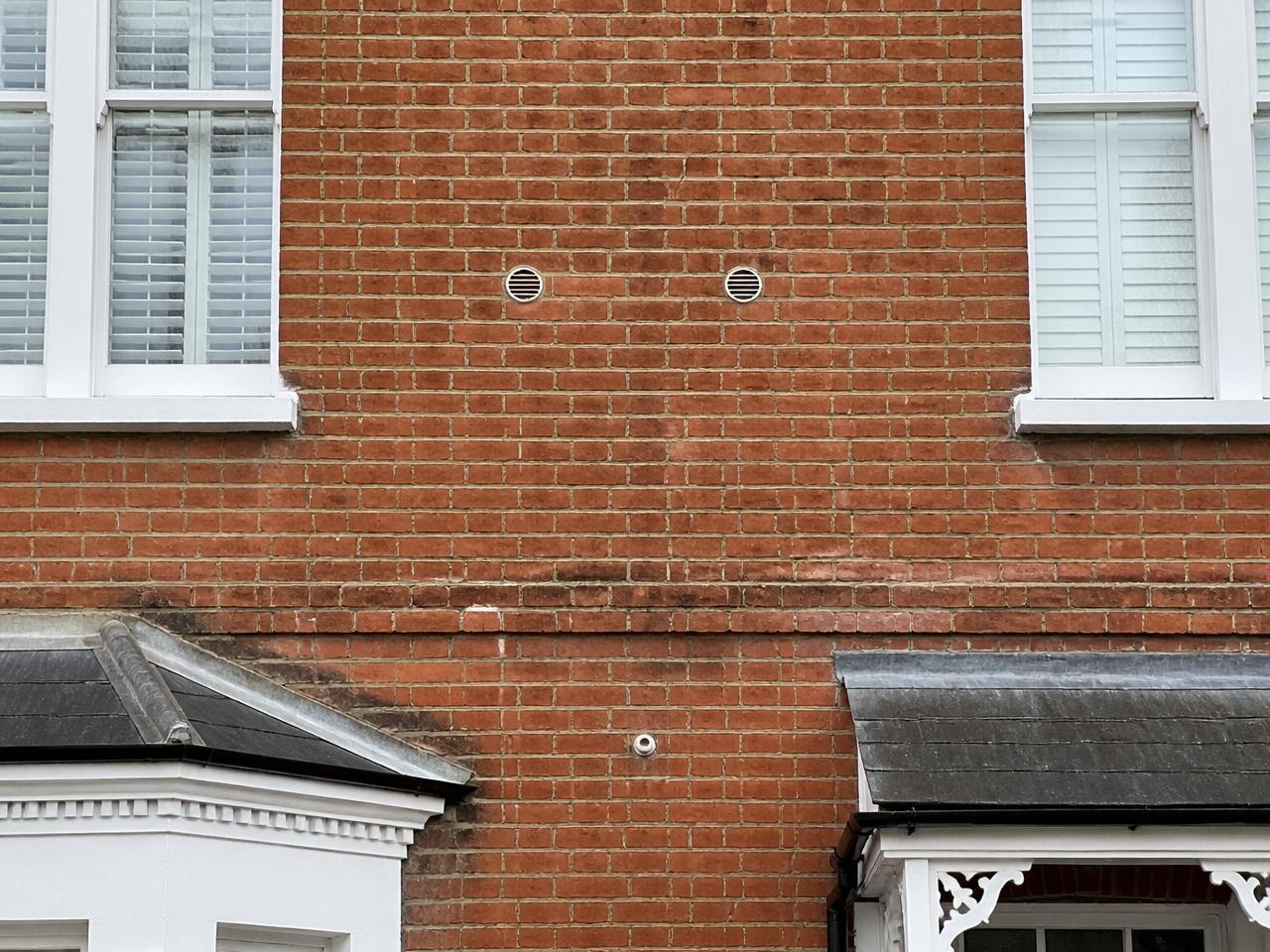 Same wall with only two small round louvred vents - a Sansvent monobloc install.